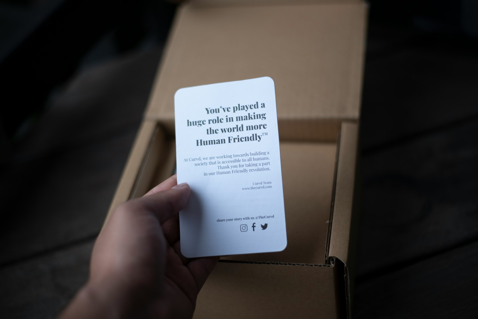 a person is holding a card in a box